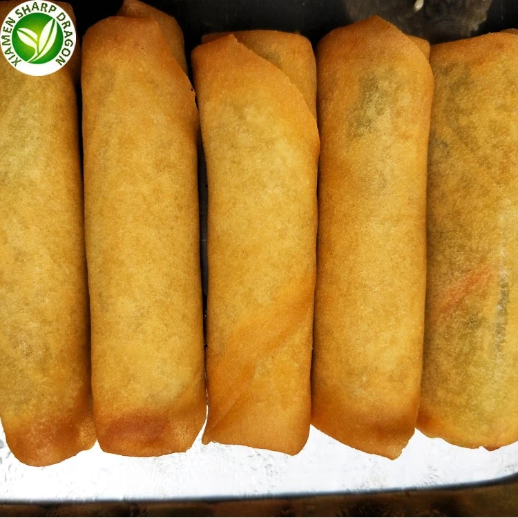 Browned spring-roll wrappers on a serving tray Golden spring rolls arranged side by side on a metal tray